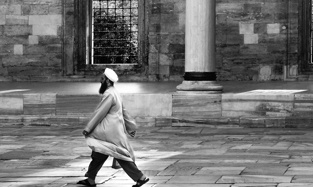 man walking in mosque yard  .pexels