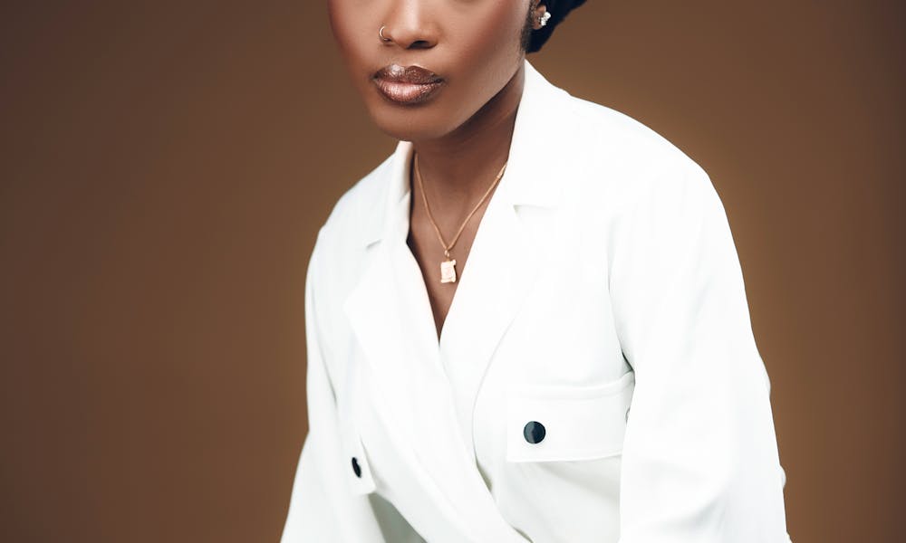 Stylish portrait of a young woman in a studio setting showcasing modern elegance and fashion. .pexels