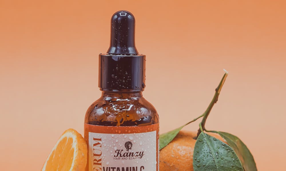 Face serum with vitamin C and orange slices on orange background for skincare. .pexels