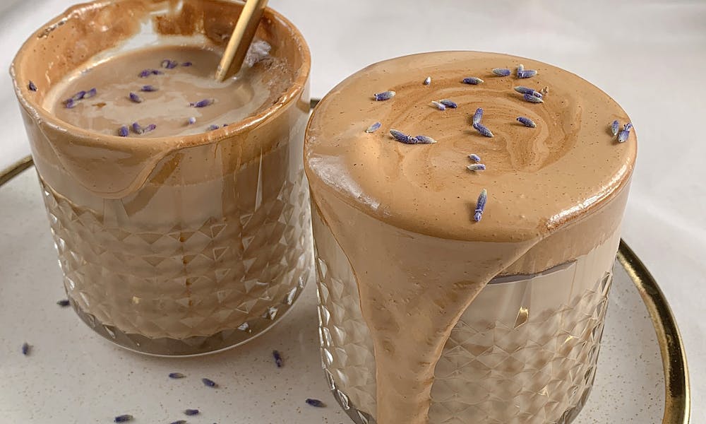 Indulge in a creamy dalgona coffee adorned with delicate lavender petals, perfect for a stylish coffee break. .pexels