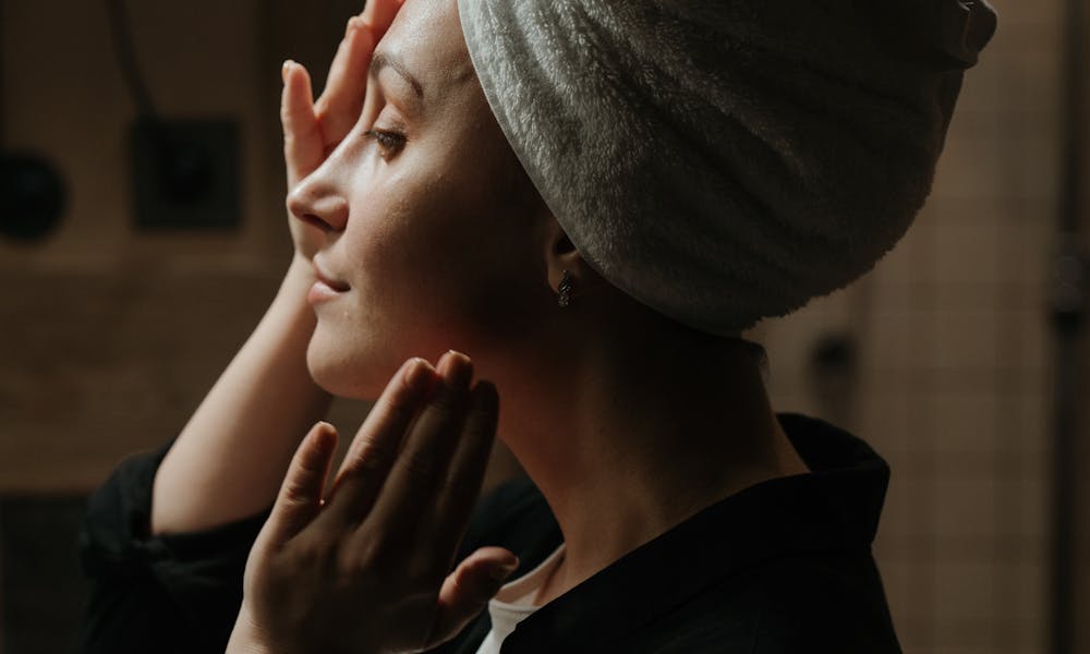 A woman indulges in a soothing skincare routine at home, promoting wellness and tranquility. .pexels