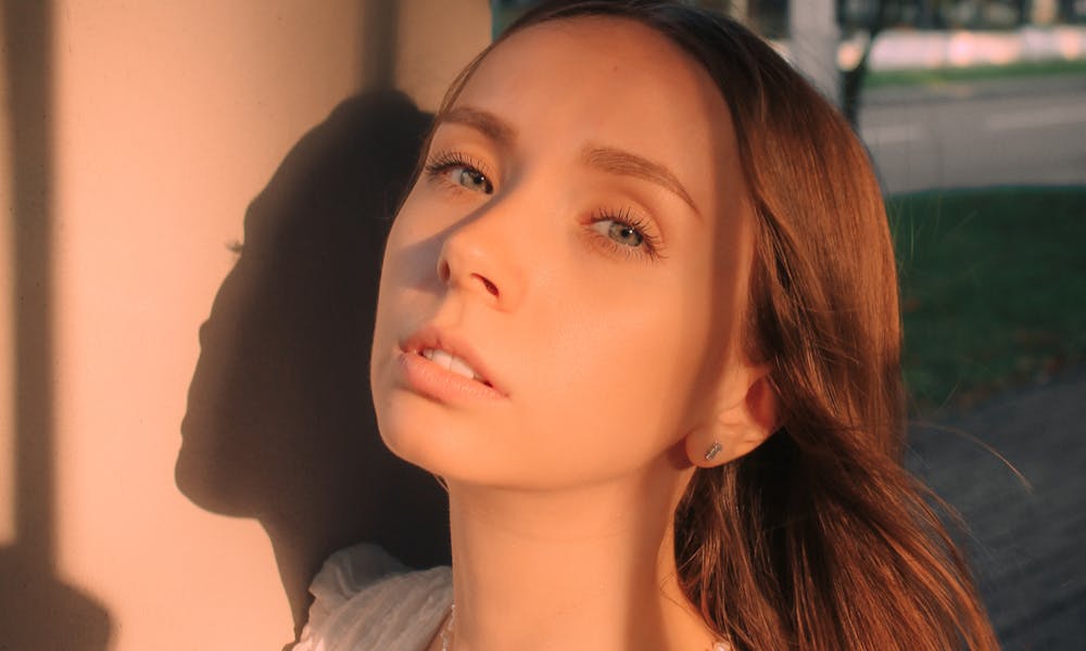 Elegant portrait of a woman bathed in warm, golden hour sunlight, outdoors. .pexels