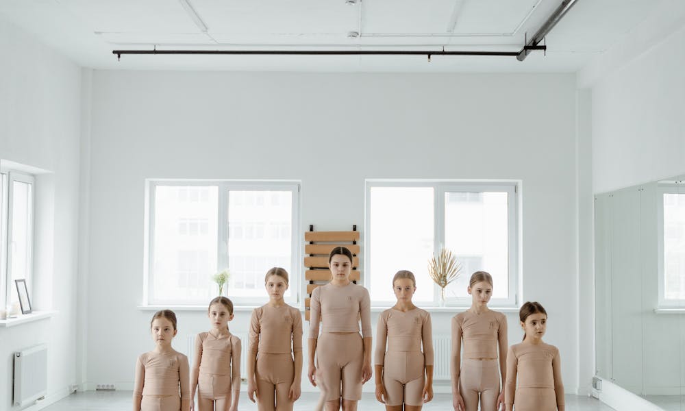 Group of children practicing ballet in a bright, spacious studio. .pexels