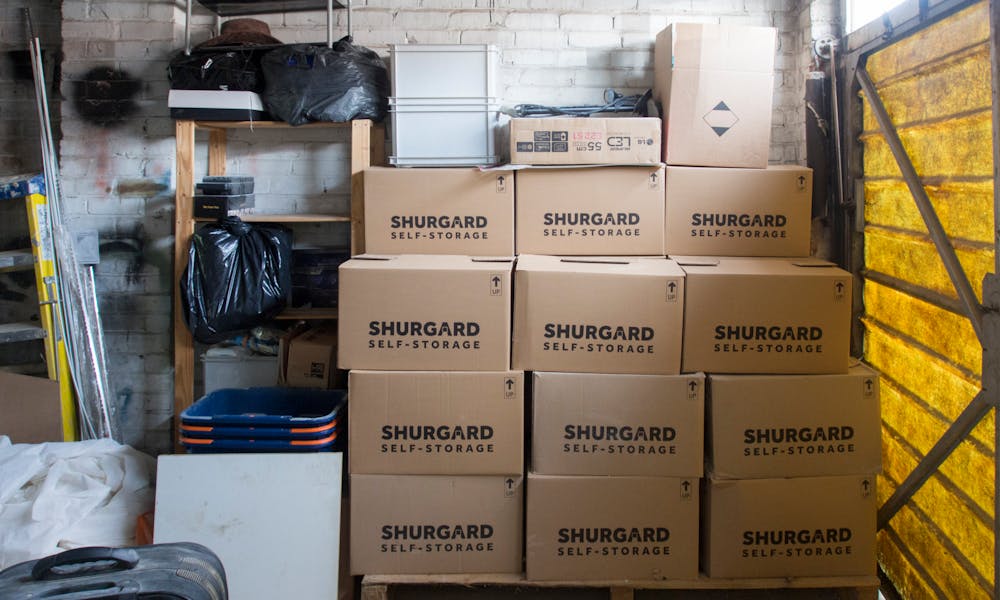 A stack of storage boxes in a well-organized warehouse interior. .pexels