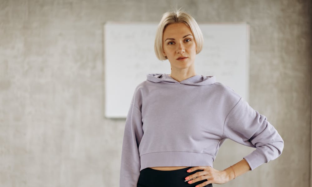 Portrait of a confident female fitness instructor in a gym, showcasing a healthy lifestyle and athletic wear. .pexels